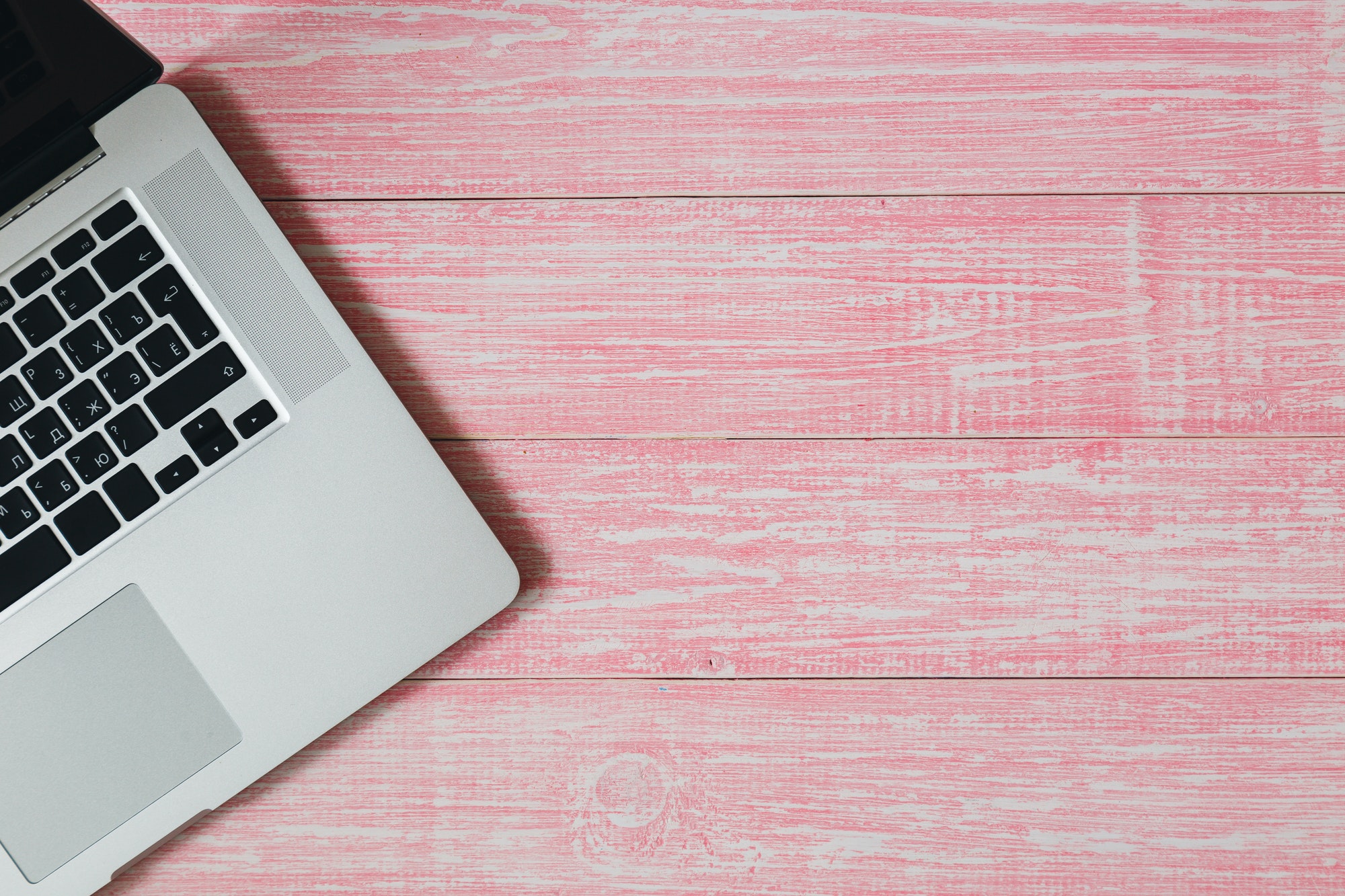 Laptop on a pink wooden desk